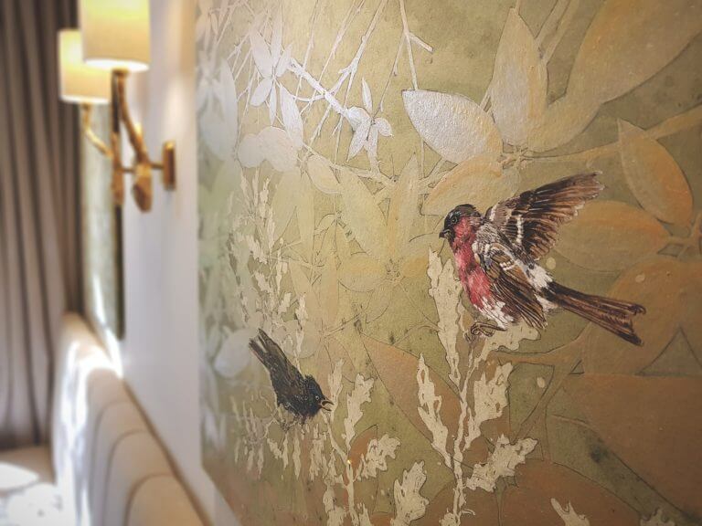 Piece of art on hotel bedroom wall showing birds on a canvas