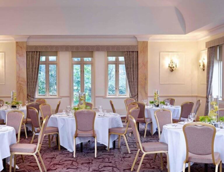 Hotel conference room set up for dining with banqueting tables