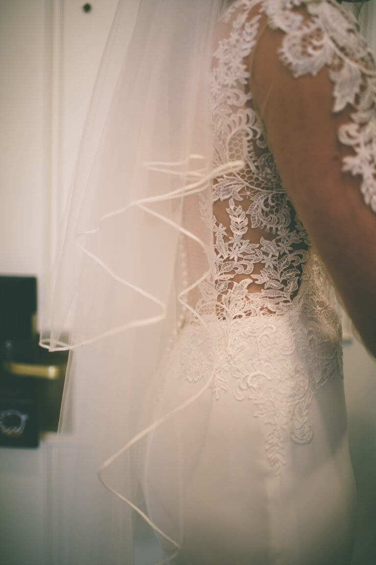 Close up of the lace on a brides wedding dress.