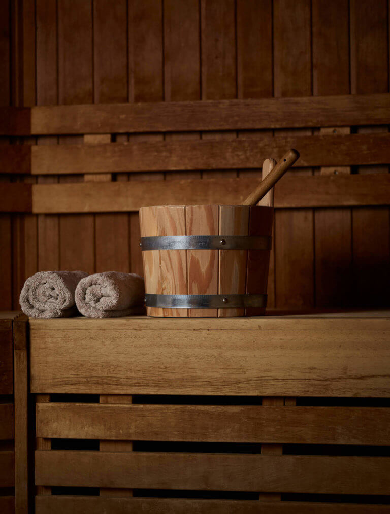 Swedish Sauna at Careys Manor with a swedish sauna bucket and two rolled up towels.