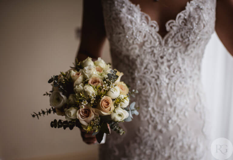 Detail shot of bridal bouquet and dress