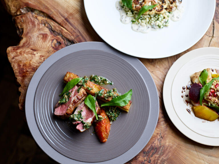 Three dinner options at Cambium restaurant on wooden table