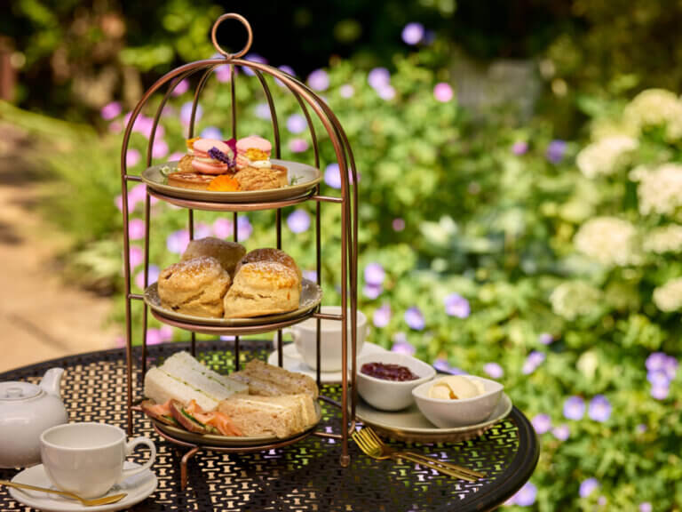 Summer afternoon tea served in the garden at Careys Manor Hotel & SenSpa in The New Forest