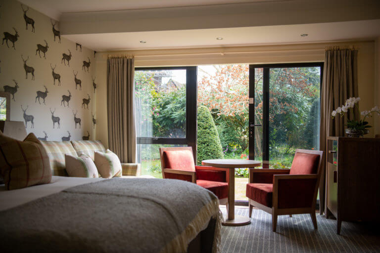 Superior bedroom with a garden view at Careys Manor Hotel