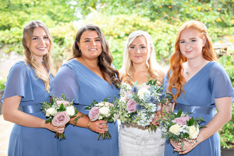 Bridesmaids and the bride outside at Careys Manor Hotel, New Forest