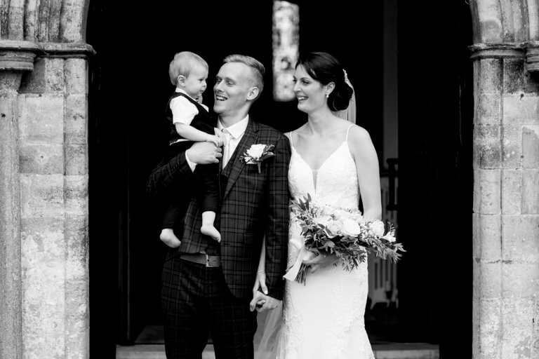 Bride and groom with little boy on wedding day