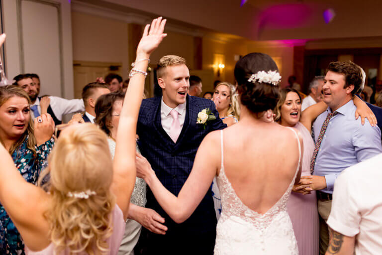 Hayley & Mike celebrate with their friends during the wedding reception at Careys Manor Hotel