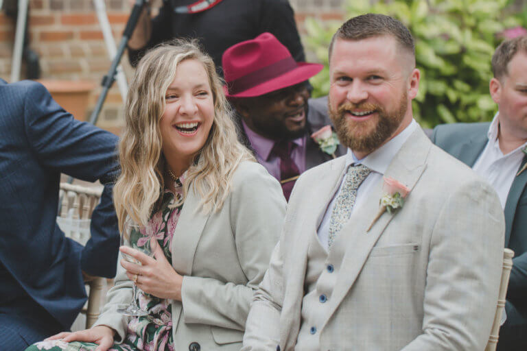 Guests smiling waiting for the bride at Hampshire Wedding venue Careys Manor Hotel