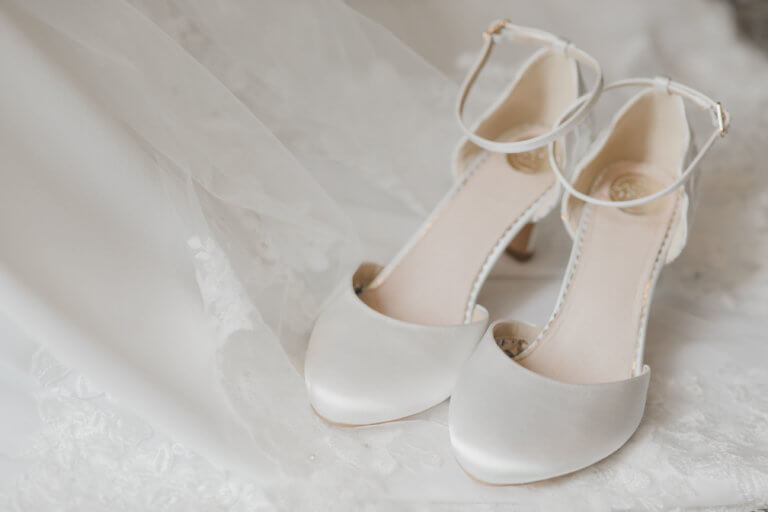 Bridal shoes shown on a bed - Hannah & Bens New Forest Wedding at Careys Manor Hotel