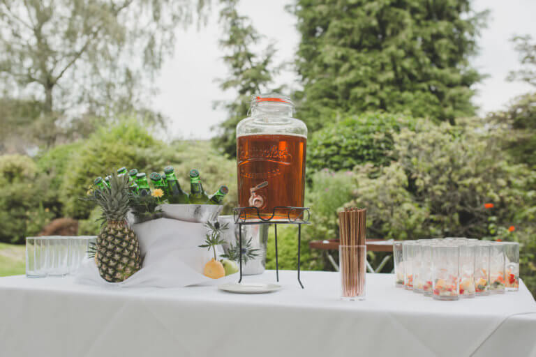 Kilner jar full of pimms and glasses set for the drinks reception at Hampshire Wedding venue Careys Manor Hotel