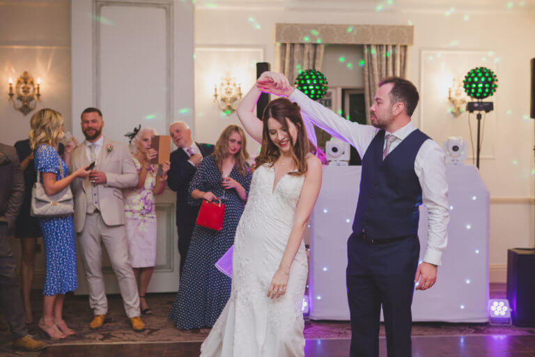 The Bride and Groom dance their first dance at Hampshire wedding venue Careys Manor Hotel