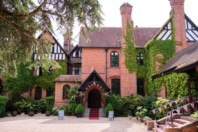 Front exterior of Careys Manor with Jubilee Bunting