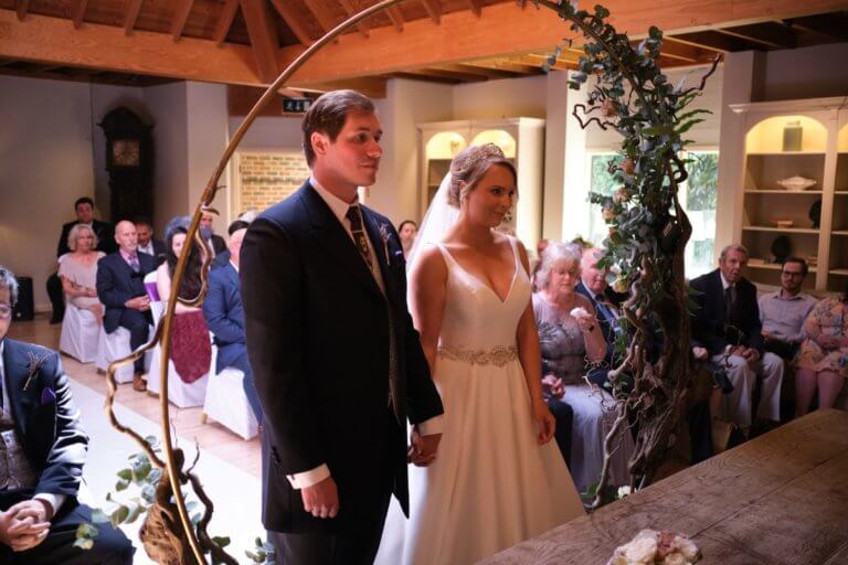 Bride and Groom stand at the registrars table