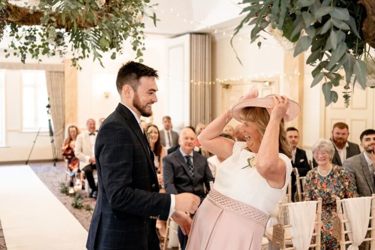 The Groom and the Mother of the Bride laugh before the ceremony commences