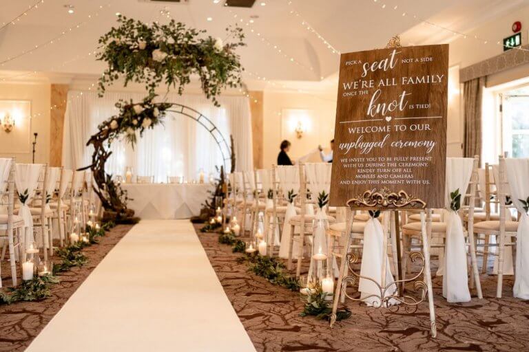 The Cedar suite set for the ceremony with a large floral hoop at the end with a white carpet approaching it