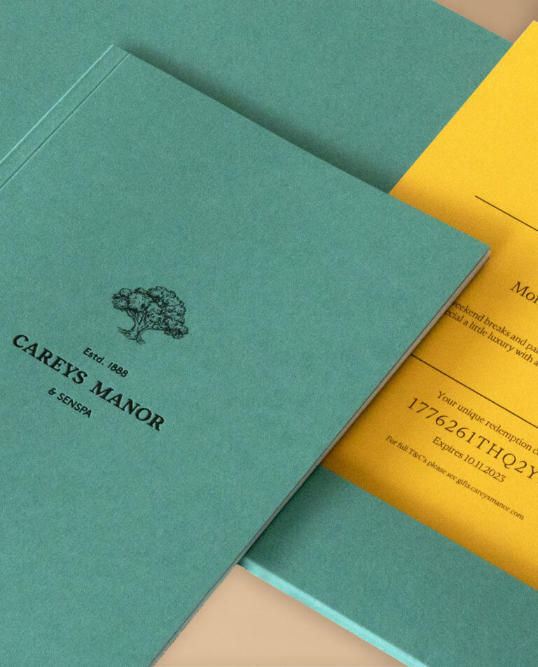 A green A5 brochure and wallet with a yellow gift certificate inside.