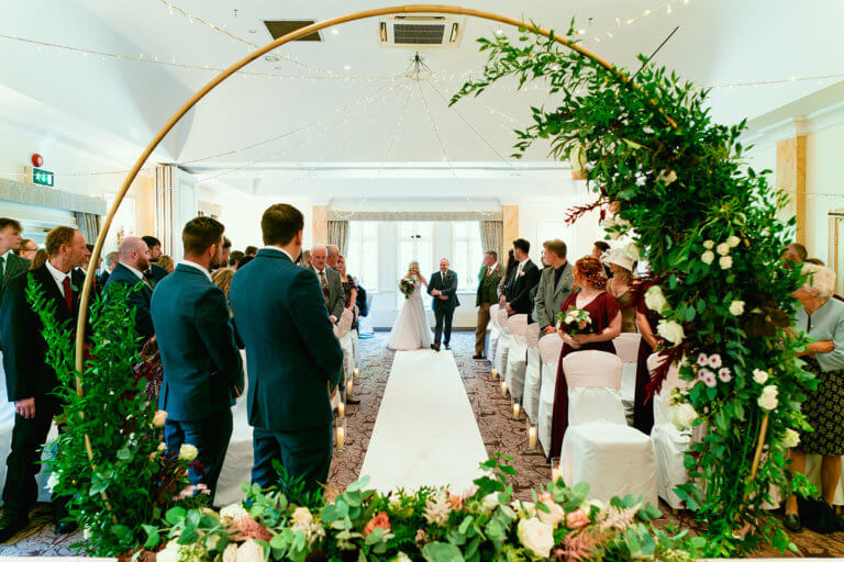 The bride and her father walk down the aisle