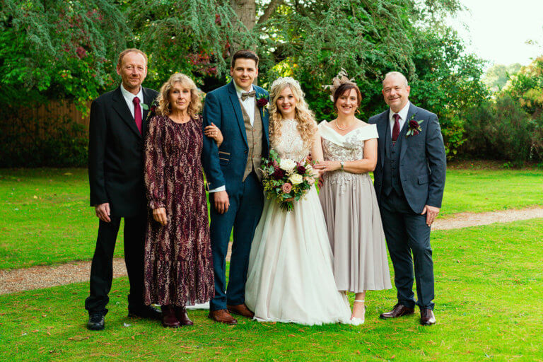 Bride and groom pose with their parents