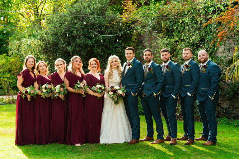 Bride and Groom pose with the grooms party and the bridesmaids