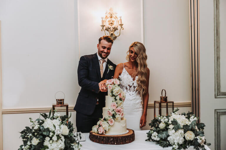 The bride and groom cut the cake