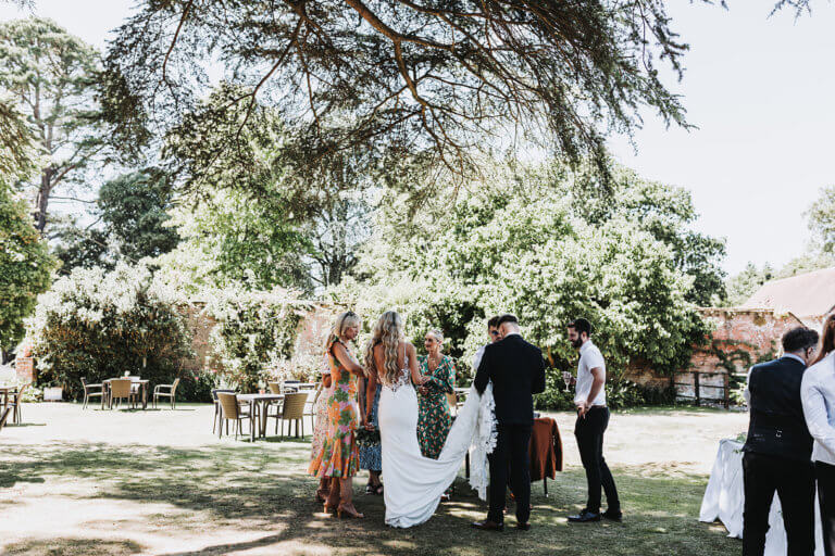 Guests gather for drinks in the hotel gardens