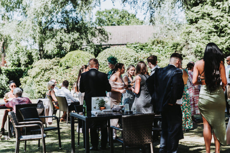 Guests enjoy drinks in the gardens