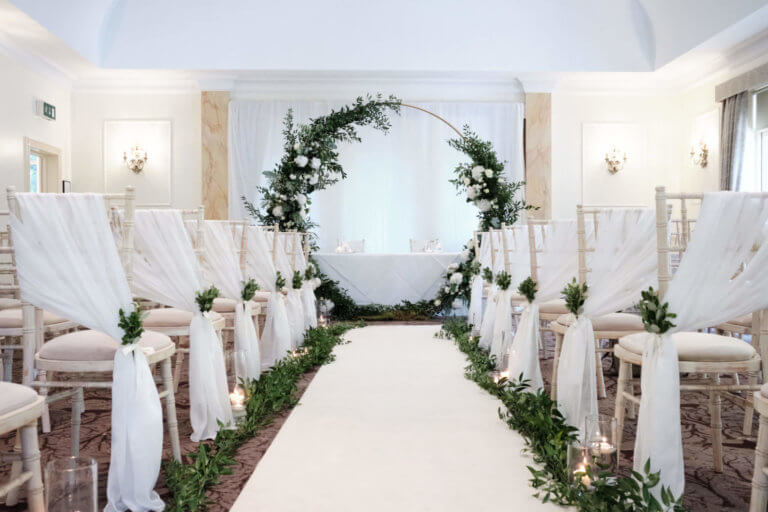 Cedar Suite Set for a wedding ceremony with white flowers & white moon gate