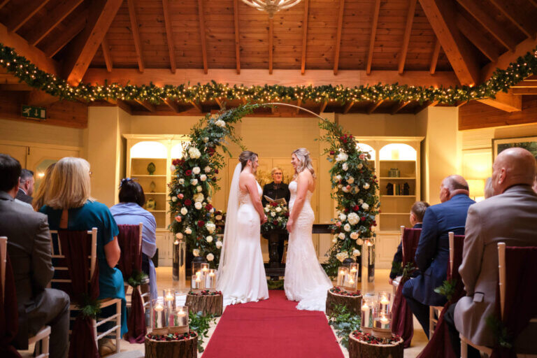 Hannah & Steph during their wedding ceremony in front of the moon gate