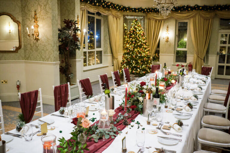 Manor Suite with a long oval table and Christmas Tree in the background