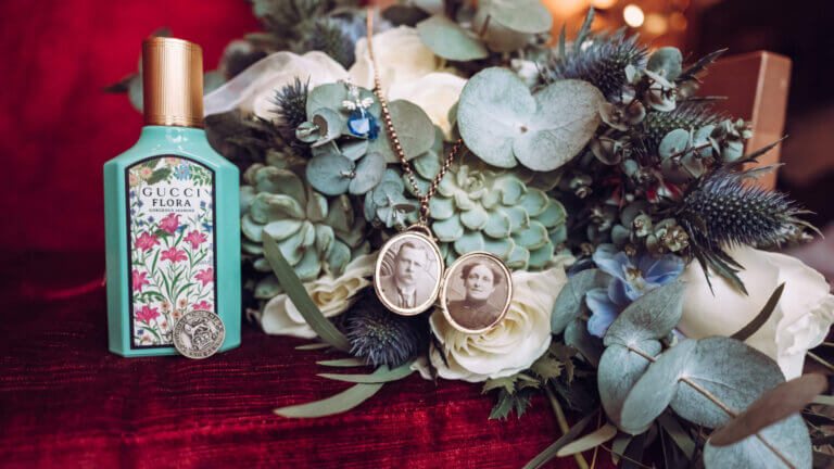 Open locket necklace with perfume bottle and bouquet