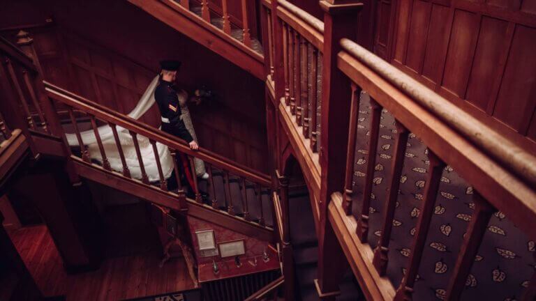 Bride and groom walk down the stairs