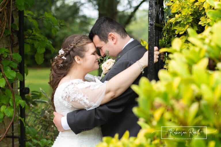 Bride and groom embrace in the gardens at Careys Manor Hotel & SenSpa wedding venue in The New Forest