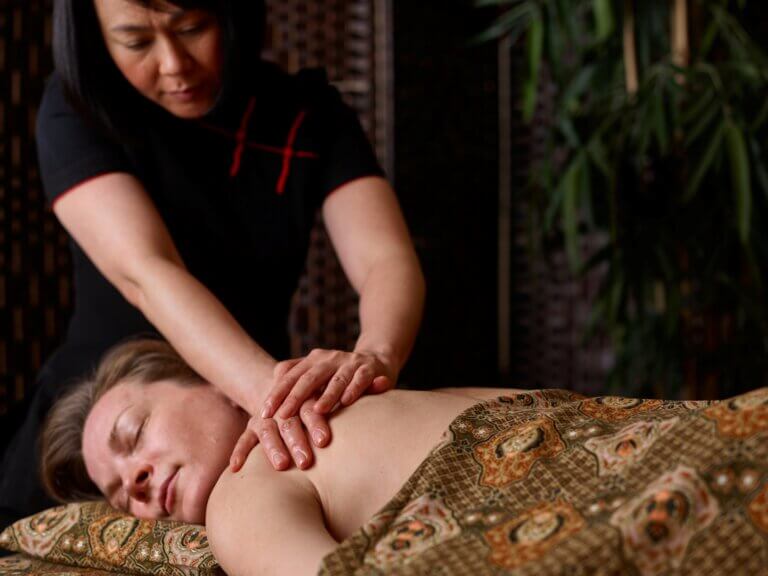 Woman receiving shoulder massage for menopause at SenSpa