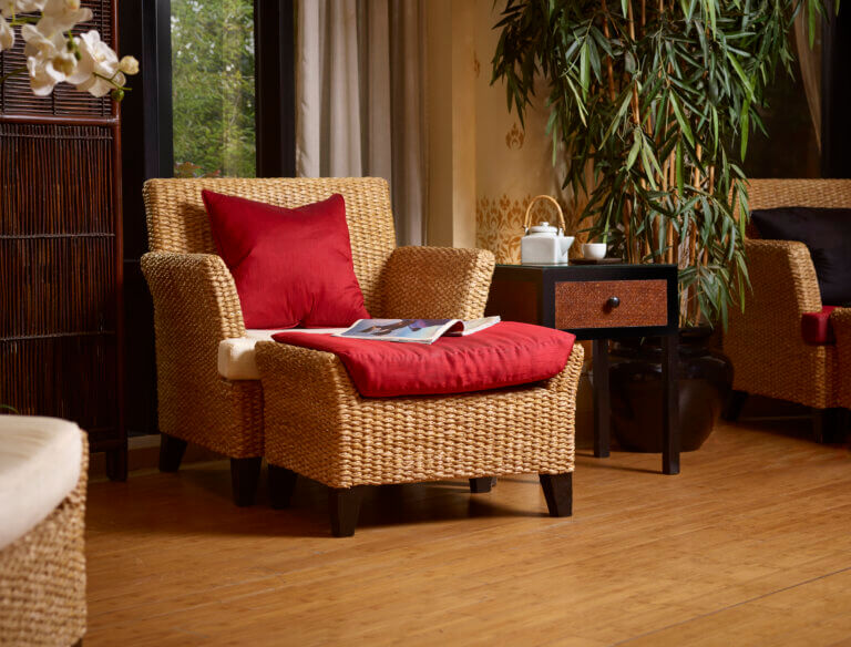 Cosy rattan chair with red cushions in relaxation room at SenSpa