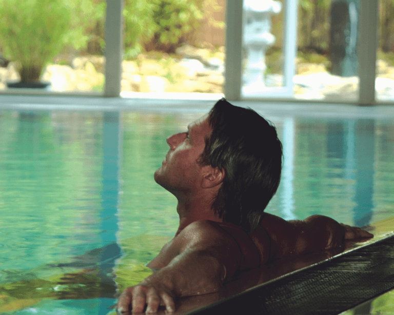 Man relaxing in the pool at a spa