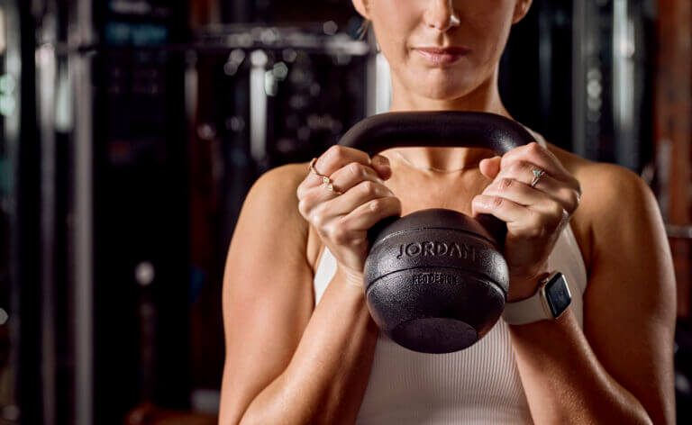 Woman lifts kettlebell at SenSpa Gym in Brockenhurst, New Forest