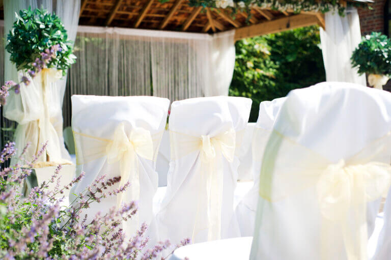 Outdoor wedding ceremony set up on sunny day at Careys Manor Hotel wedding venue