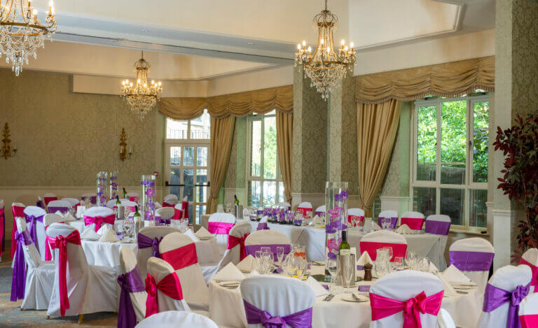 Wedding breakfast set up at Careys Manor hotel with pink and purple theme