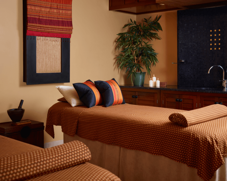 Two massage beds in double treatment room at SenSpa Thai spa with Thai inspired décor