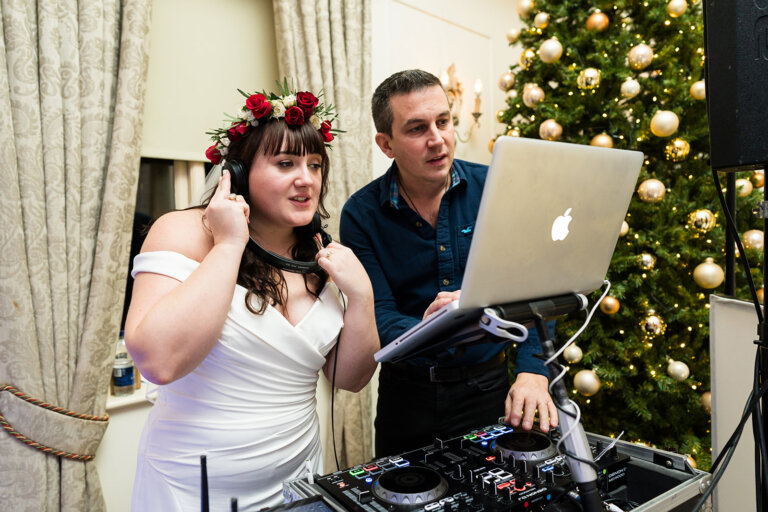Maxine & Alastair's evening reception. The bride Maxine joins the DJ wearing headphones.