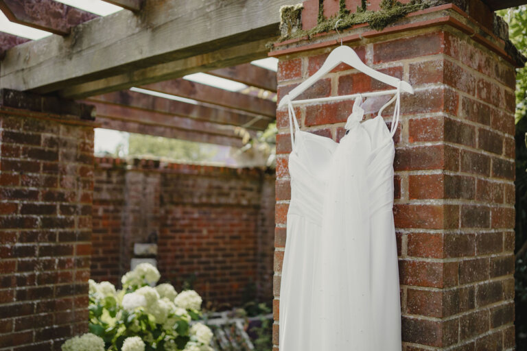 Wedding dress hanging in the garden. Close up for the top half of the dress.