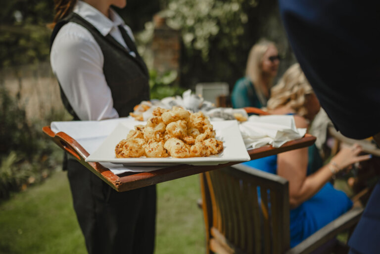 Waiting staff holding canapes