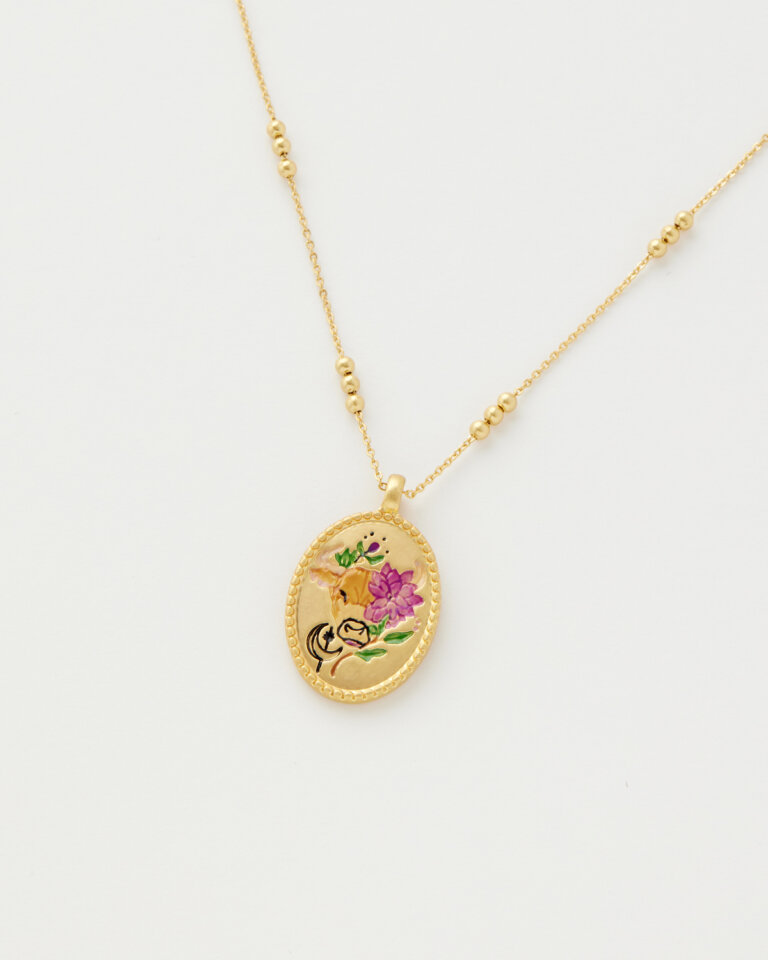 Gold necklace with colourful zodiac inspired design on pendant